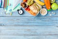 Back to school concept. Healthy lunch box and colorful stationery on turquoise wooden table top view. Royalty Free Stock Photo