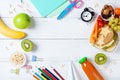 Back to school concept. Healthy lunch box and colorful stationery on white wooden table top view. Royalty Free Stock Photo