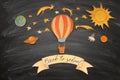 Back to school concept. Hot air balloon, space elements shapes cut from paper and painted over classroom blackboard background. Royalty Free Stock Photo