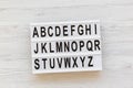 Back to school concept. Letters from A to Z. English alphabet on modern board over white wooden background, top view. From above, Royalty Free Stock Photo