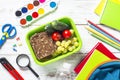 Back to school concept. Lunch box with stationery and backpack. Royalty Free Stock Photo