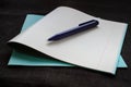 Back to school concept. Notebook with notice paper and pen on black background Royalty Free Stock Photo