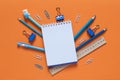 Back to school concept. School and office supplies on the office table. Orange background.Flat lay Royalty Free Stock Photo