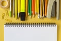Back to school concept. Open empty mockup notebook and colored school stationery. Yellow paper background. Flat lay, top view, Royalty Free Stock Photo