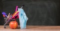 Back to school concept with pencils, crayons in shopping cart with apple with face mask Royalty Free Stock Photo