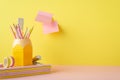 Back to school concept. Photo of pink and yellow stationery stack of notebooks stand for colour pencils mini stapler adhesive tape Royalty Free Stock Photo