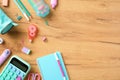 Back to school concept. Pink and turquoise colors school stationery, calculator, pencil case, paper notebook on wooden desk table Royalty Free Stock Photo