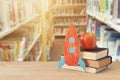 Back to school concept. rocket and books in front of blurry Library background. Royalty Free Stock Photo