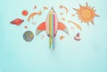Back to school concept. rocket, space elements shapes cut from paper and painted over wooden blue background. Royalty Free Stock Photo