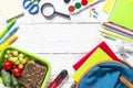 Back to school concept. Lunch box with stationery and backpack. Royalty Free Stock Photo
