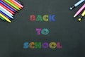 Back to school concept. school supplies on black board background. \