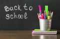Back to school. School supplies, copybook and pen. Copy space on chalkboard.