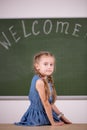 Back to school concept. schoolgirl chalkboard in classroom.