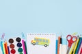 Back to school concept. Set of different school supplies and yellow bus on blue background. copy space, top view, flat lay Royalty Free Stock Photo
