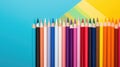 Back to school concept, sharp colored pencils for drawing lie in a row on yellow blue background copy space, top view, flat lay Royalty Free Stock Photo