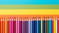 Back to school concept, sharp rainbow pencils in a row isolated on striped color background with copy space, top view, flat lay Royalty Free Stock Photo