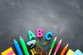 Back to school concept. stationery and books over classroom blackboard. top view, flat lay Royalty Free Stock Photo