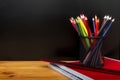 Back to School Concept with Stationery Supplies and Blackboard. Pencil box, pencils, notebook, ruler, pencil sharpener Royalty Free Stock Photo