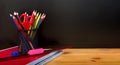 Back to School Concept with Stationery Supplies and Blackboard. Pencil box, pencils, notebook, ruler, pencil sharpener and Royalty Free Stock Photo