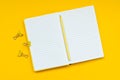 Back to school concept. School supplies: open notebook and pen on yellow background. Top view. Copy space. Flat lay. Mock-up Royalty Free Stock Photo