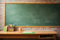 Green blackboard on brick wall and desk in front, back to school. Generative ai Royalty Free Stock Photo