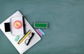 Back to school concept with technology and stationery on a green chalkboard background Royalty Free Stock Photo