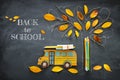 Back to school concept. Top view image of school bus and pencils next to tree sketch with autumn dry leaves over classroom blackbo Royalty Free Stock Photo