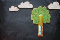 Back to school concept. Top view image tree of knowledge and pencils over classroom blackboard background.
