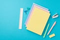 Back to school concept. Top view photo of colorful stationery stack of notebooks mini stapler pens eraser ruler and binder clips Royalty Free Stock Photo