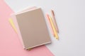 Back to school concept. Top view photo of school supplies stack of notebooks and pens on bicolor pink and white background Royalty Free Stock Photo