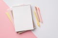 Back to school concept. Top view photo of school supplies stack of notebooks and pens on bicolor pink and white background Royalty Free Stock Photo