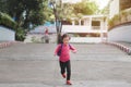 Back to school concept, Young asian cute kid or pupil running into school at morning, Selective focus Royalty Free Stock Photo