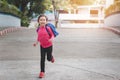 Back to school concept, Young asian cute kid or pupil running into school at morning, Selective focus Royalty Free Stock Photo