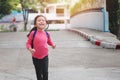 Back to school concept, Young asian cute kid or pupil running into school at morning, Selective focus Royalty Free Stock Photo