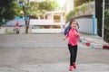 Back to school concept, Young asian cute kid or pupil running into school at morning, Selective focus Royalty Free Stock Photo