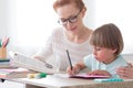 Mother helping son with homework Royalty Free Stock Photo