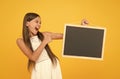 back to school. copy space. summer vacation and holiday. happy childhood. little girl pointing finger blackboard Royalty Free Stock Photo