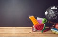 Back to school creative background with watermelon pencil case and school supplies on wooden table