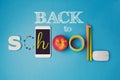 Back to school creative design with smartphone, apple and school supplies. Royalty Free Stock Photo