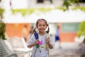 Back to school. Cute Asian child girl with a backpack running and going to school with fun Royalty Free Stock Photo