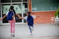 Back to school. Cute Asian child girl with a backpack running and going to school with fun Royalty Free Stock Photo