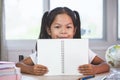 Back to school. Cute asian child girl holding a book Royalty Free Stock Photo