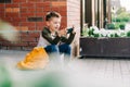 Back to school. Cute child with backpack, holding mobile phone, playing with cellphone. School boy pupil with bag Royalty Free Stock Photo