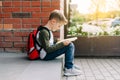 Back to school. Cute child with backpack, holding notepad and training books. School boy pupil with bag. Elementary Royalty Free Stock Photo