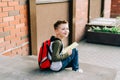 Back to school. Cute child with backpack, holding notepad and training books. School boy pupil with bag. Elementary Royalty Free Stock Photo