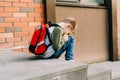 Back to school. Cute child with backpack, holding notepad and training books. School boy pupil with bag. Elementary Royalty Free Stock Photo