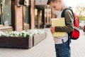 Back to school. Cute child with backpack holding notepad and training books going to school. Boy pupil with bag Royalty Free Stock Photo