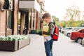 Back to school. Cute child with backpack holding notepad and training books going to school. Boy pupil with bag Royalty Free Stock Photo