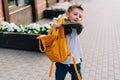 Back to school. Cute child packing backpack, holding notepad and training books going to school. Boy pupil with bag Royalty Free Stock Photo