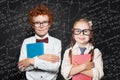 Back to school. Cute kids portrait. Little girl and boy school student holding book Royalty Free Stock Photo